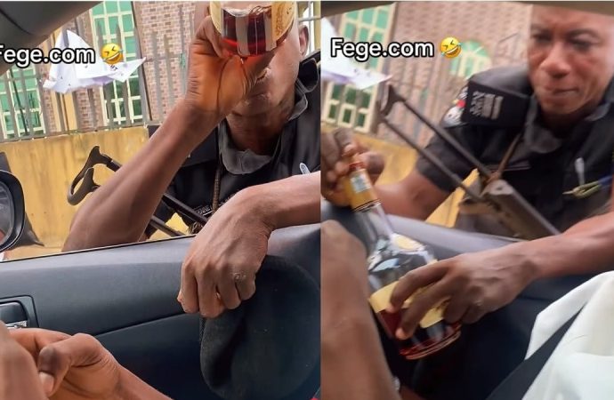 Viral Video Shows Armed Nigerian Police Officer Allegedly Drinking Hennessy While on Duty — Akelicious